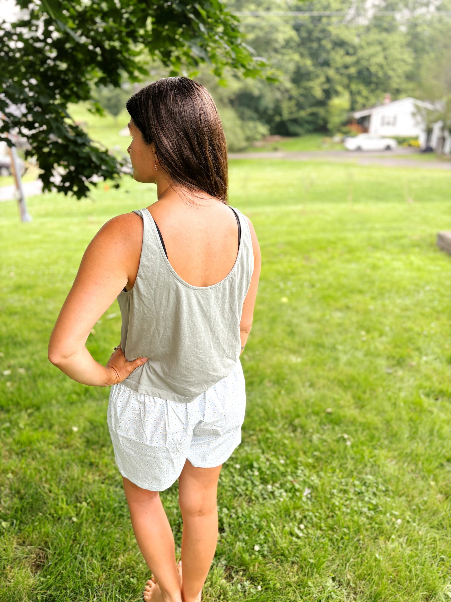 back of woman wearing mom crop tank in sage green