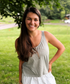 woman smiling at camera wearing mom crop tank in sage green