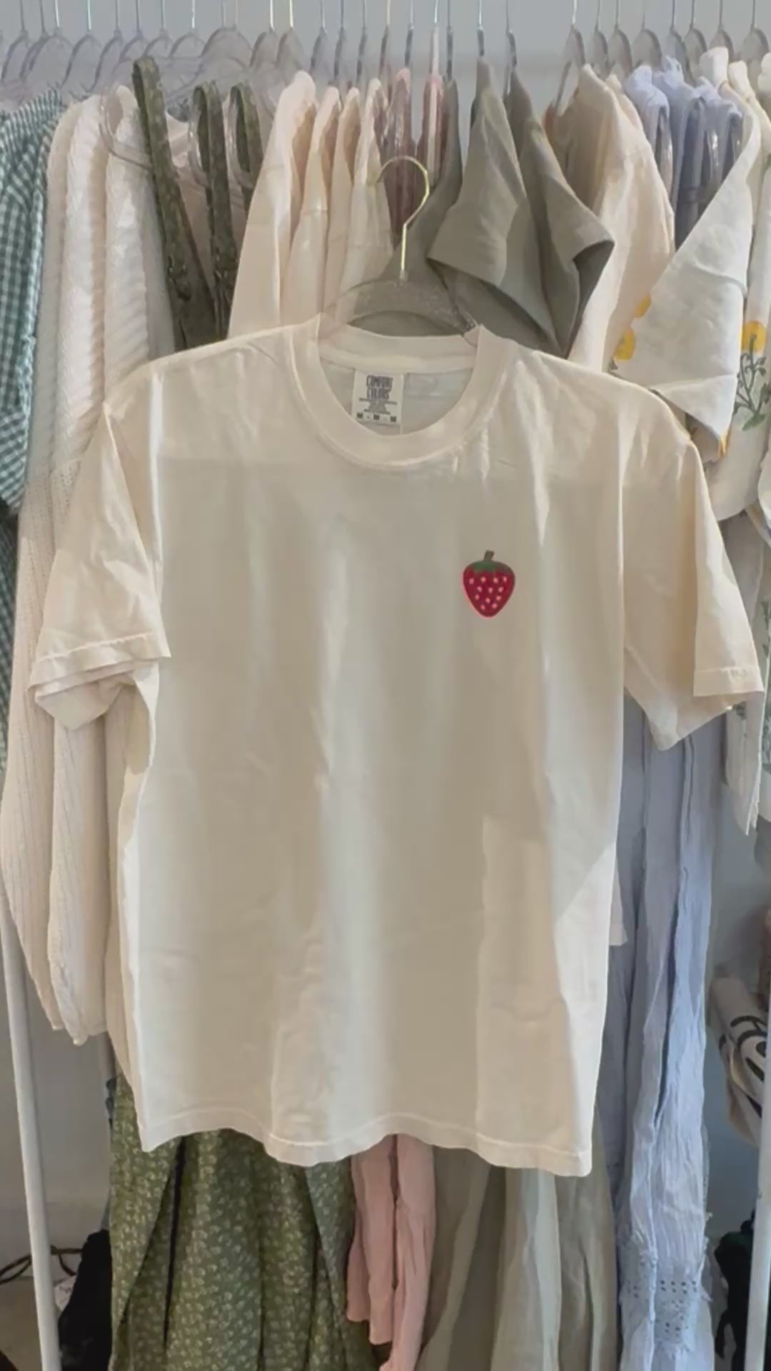 video of summer graphic tee with embroidered strawberry on front and fruit of the spirit verses on back